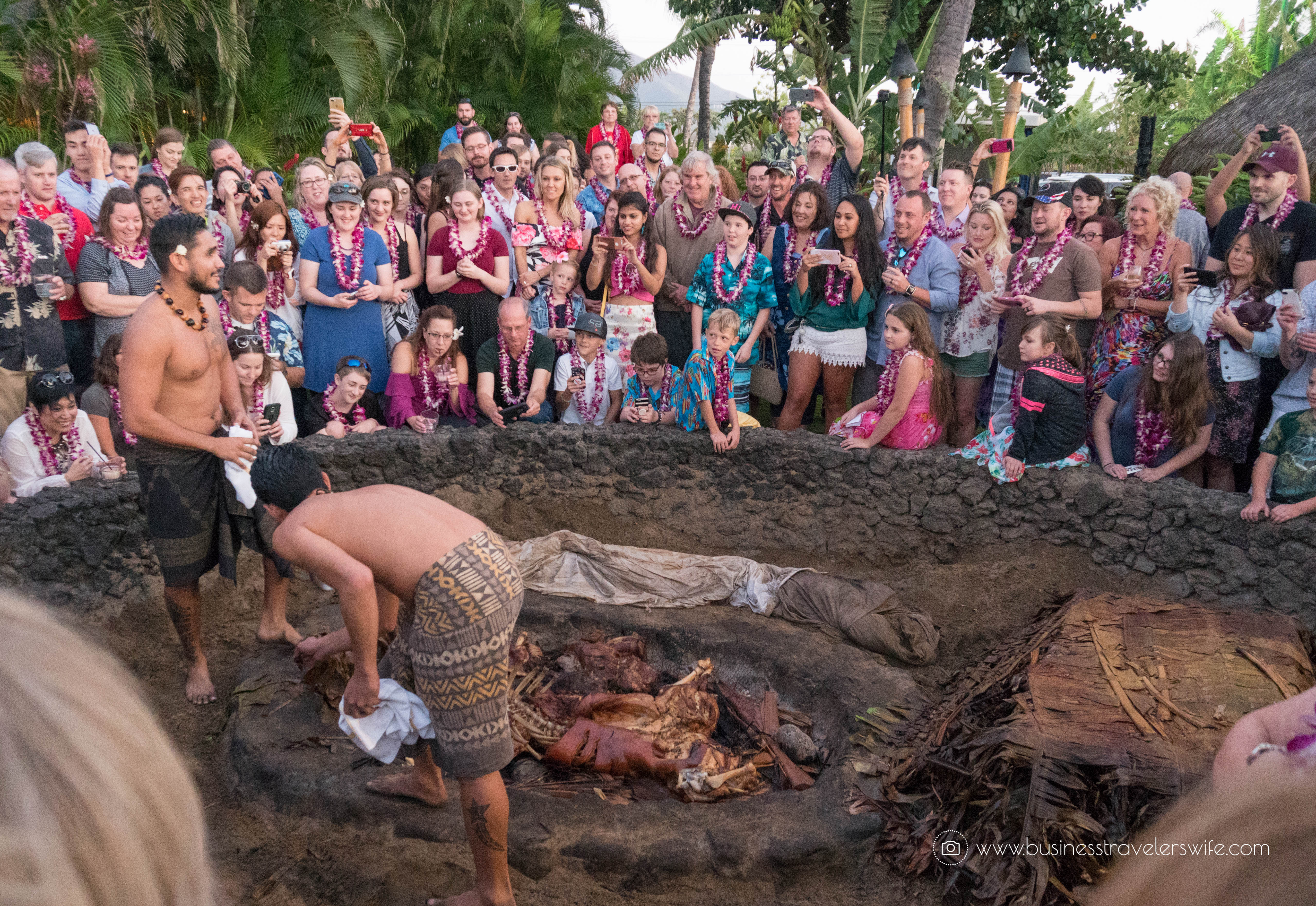 A Feast for the Belly and the Eyes at Old Lahaina Luau in Maui, Hawaii Pineapple Table Pua'a Ka'lua Imu Roasted Pig Underground Oven Crowd